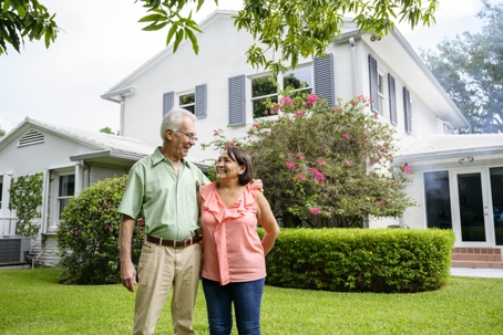 Seniors standing together in backyard